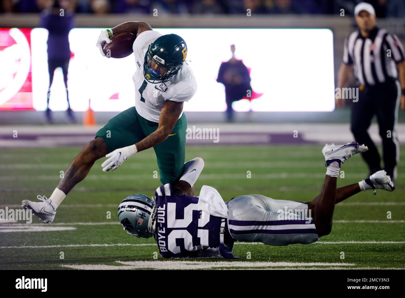 Baylor running back Trestan Ebner (1) leaps over TCU placekicker