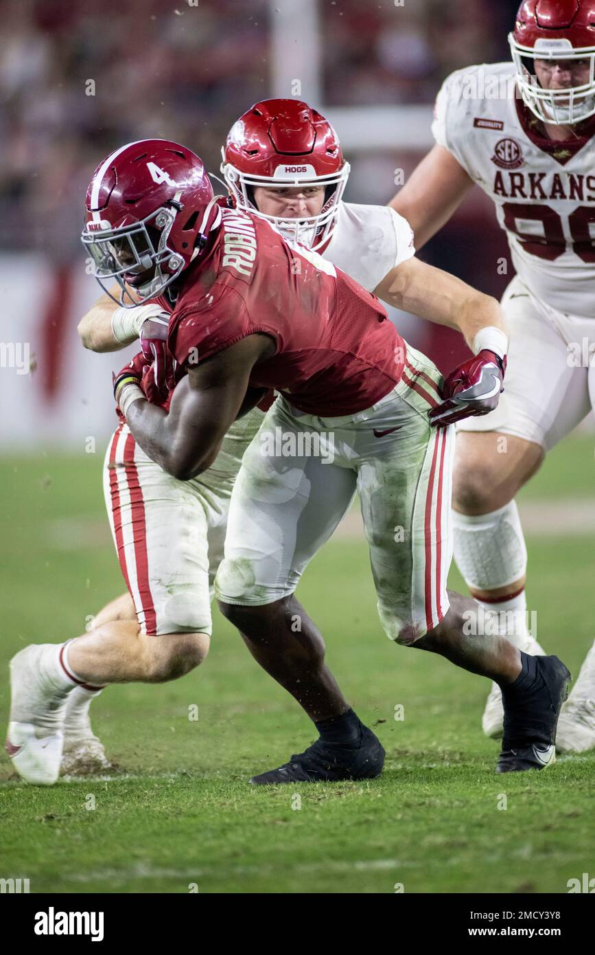 Alabama running back Brian Robinson Jr. (4) tries to gain yardage on a