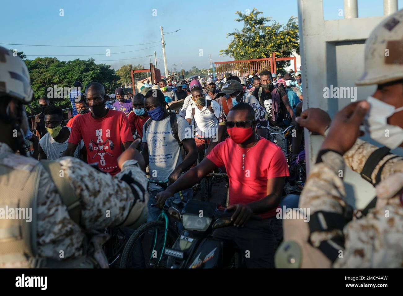 Dominican Republic Soldiers Stand Guard As Haitians Wait To Cross The Border Into The Dominican