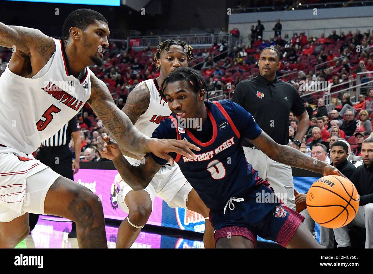 Detroit Mercy guard Antoine Davis (0) attempts to get past Louisville