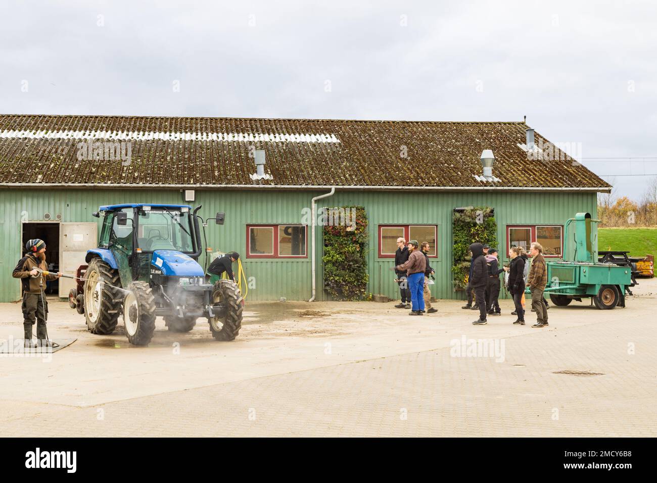 Aarhus, Denmark November 16, 2022 Cleaning tractors at farm school