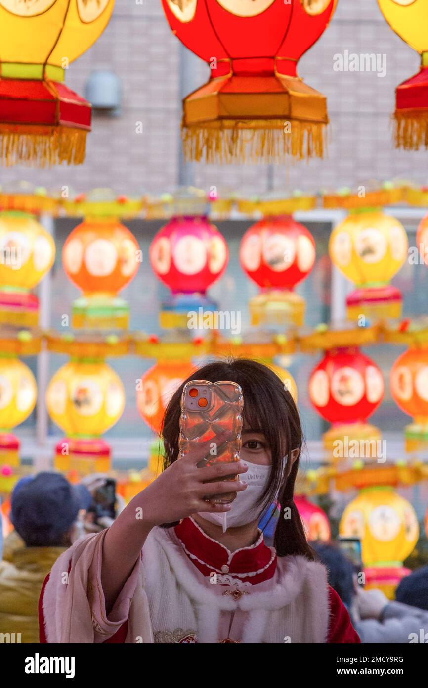 Yokohama, Japan. 22nd Jan, 2023. A Japanese woman takes a selfie under colourful lanterns as part of the Chinese Spring Festival Yokohama China Town, Kanagawa. Traditional Chinese cultural events to mark the lunar new year will happen in Yokohama's China Town from January 22nd to February 5th, 2023. Credit: SOPA Images Limited/Alamy Live News Stock Photo
