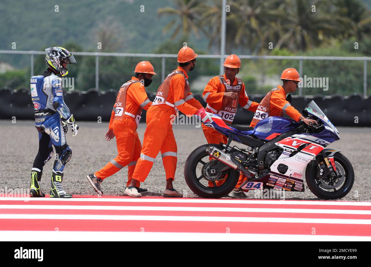 Team VFT Racing rider Federico Caricasulo of Italy, left, helped off the track after engine trouble during the Supersport world free practice 1 at Mandalika International Circuit in Mandalika, Lombok Island, Indonesia,