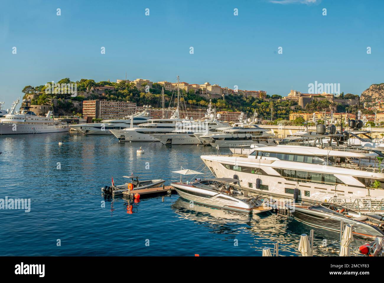 Idyllic view of the harbor (Port Hercule) of Monaco with luxury yachts and the skyline of Monaco from the Prince's Palace of Monaco in summer morning Stock Photo