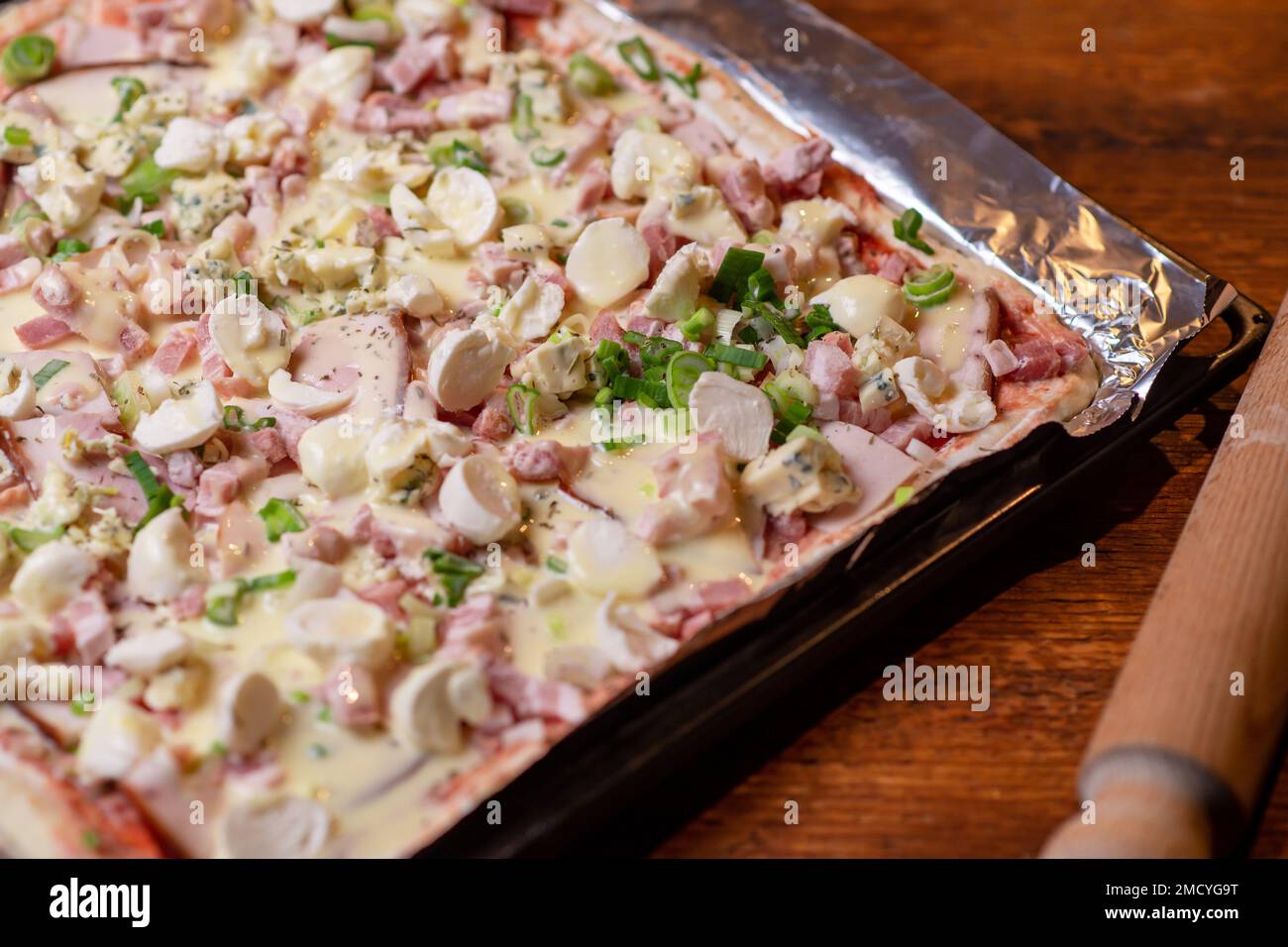 Cooking homemade pizza on a baking sheet. Pizza with mozzarella cheese