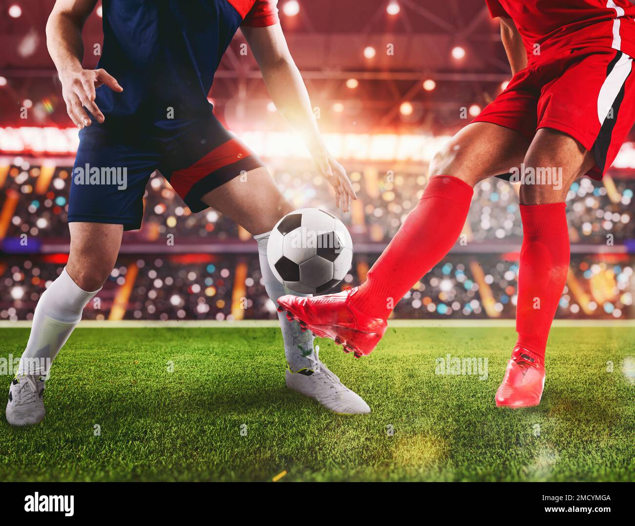 Soccer players fight for the soccerball at the stadium during the match Stock Photo