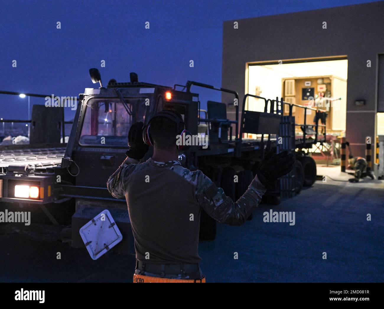 Airmen with the 379th Logistics Readiness Squadron prepare to load negative pressurized container on to a trailer during an exercise July 11, 2022 at Al Udeid Airbase, Qatar. Practicing precise moment of mission essential equipment keeps airmen prepared for emergency situations. Stock Photo