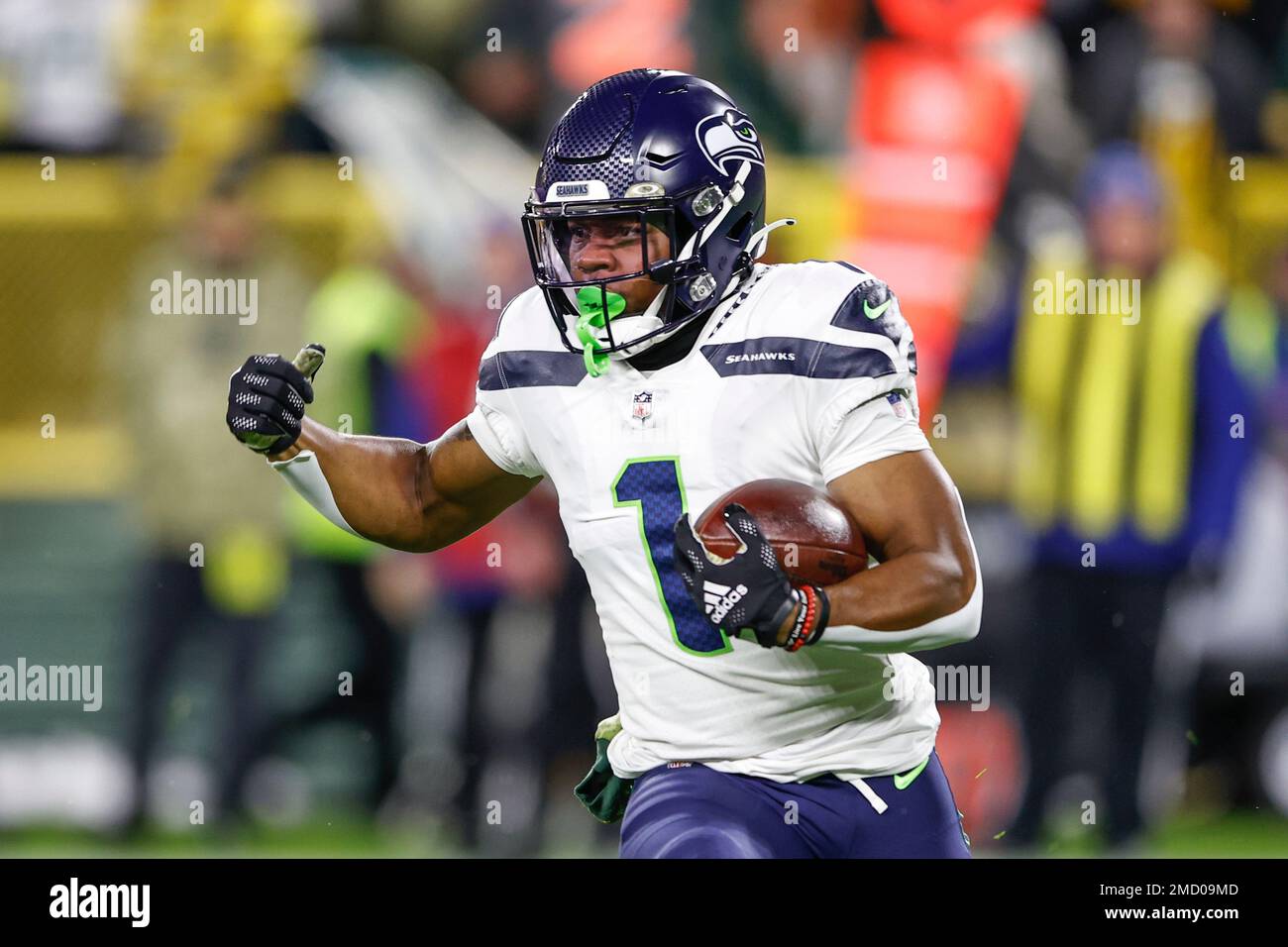 Seattle Seahawks wide receiver D'Wayne Eskridge (1) runs with the ball  during the second half of an NFL football game against the Green Bay  Packers, Sunday, Nov. 14, 2021, in Green Bay