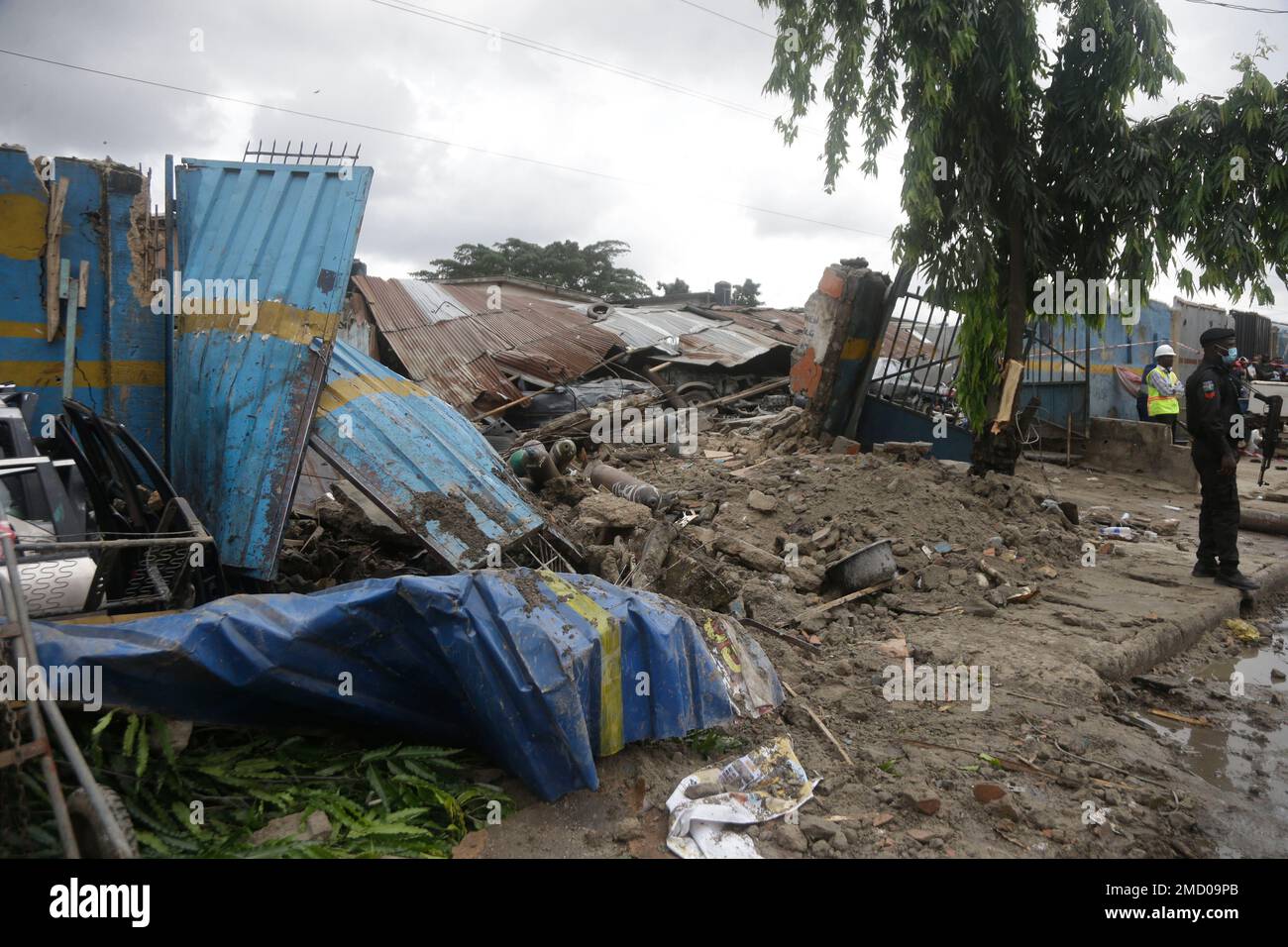 A police officer stands guard at the scene of a gas explosion in Lagos ...