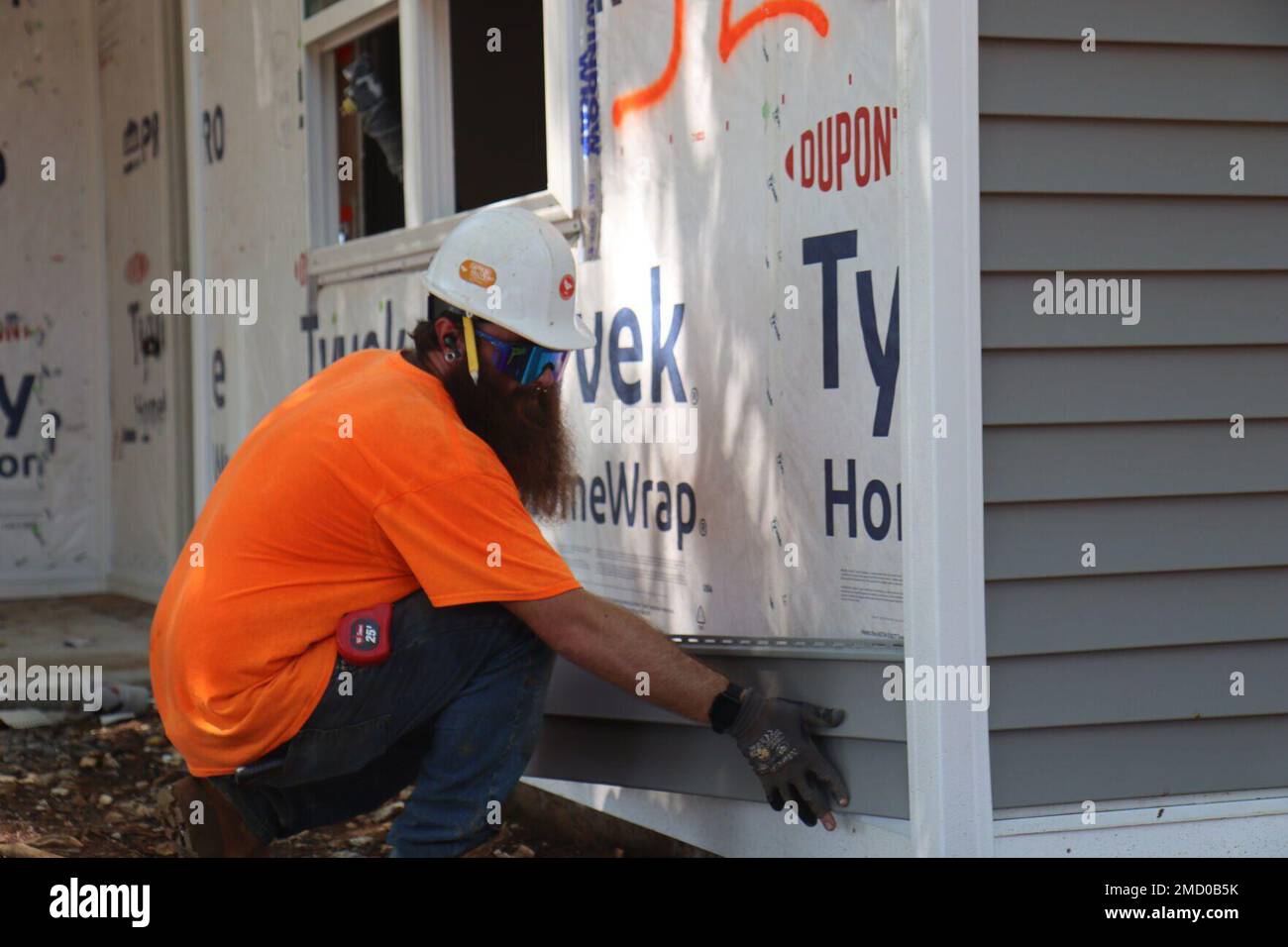 AJ Pasch, siding installer, Wallace Contracting, installs siding on the exterior of a housing unit July 11 in the New Hammond Heights community, Fort Campbell. Stock Photo