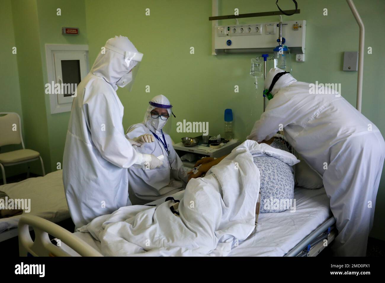 Medics wearing a special suit to protect against coronavirus treat