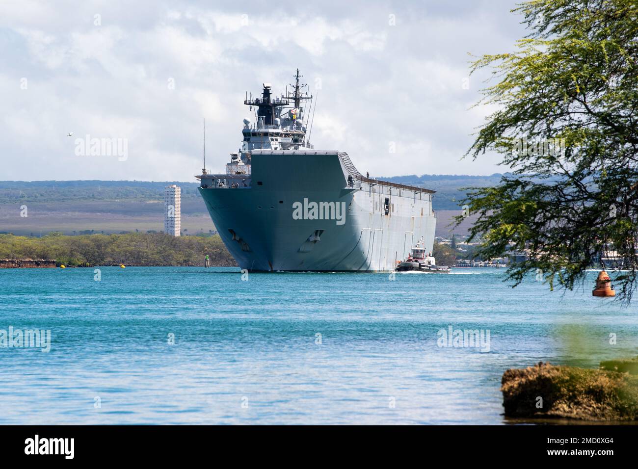 220712-N-RG360-1038  PEARL HARBOR (July 12, 2022) – Royal Australian Navy landing helicopter dock HMAS Canberra (L02) departs Pearl Harbor to begin the at-sea phase of Rim of the Pacific (RIMPAC) 2022, July 12. Twenty-six nations, 38 ships, four submarines, more than 170 aircraft and 25,000 personnel are participating in RIMPAC from June 29 to Aug. 4 in and around the Hawaiian Islands and Southern California. The world’s largest international maritime exercise, RIMPAC provides a unique training opportunity while fostering and sustaining cooperative relationships among participants critical to Stock Photo