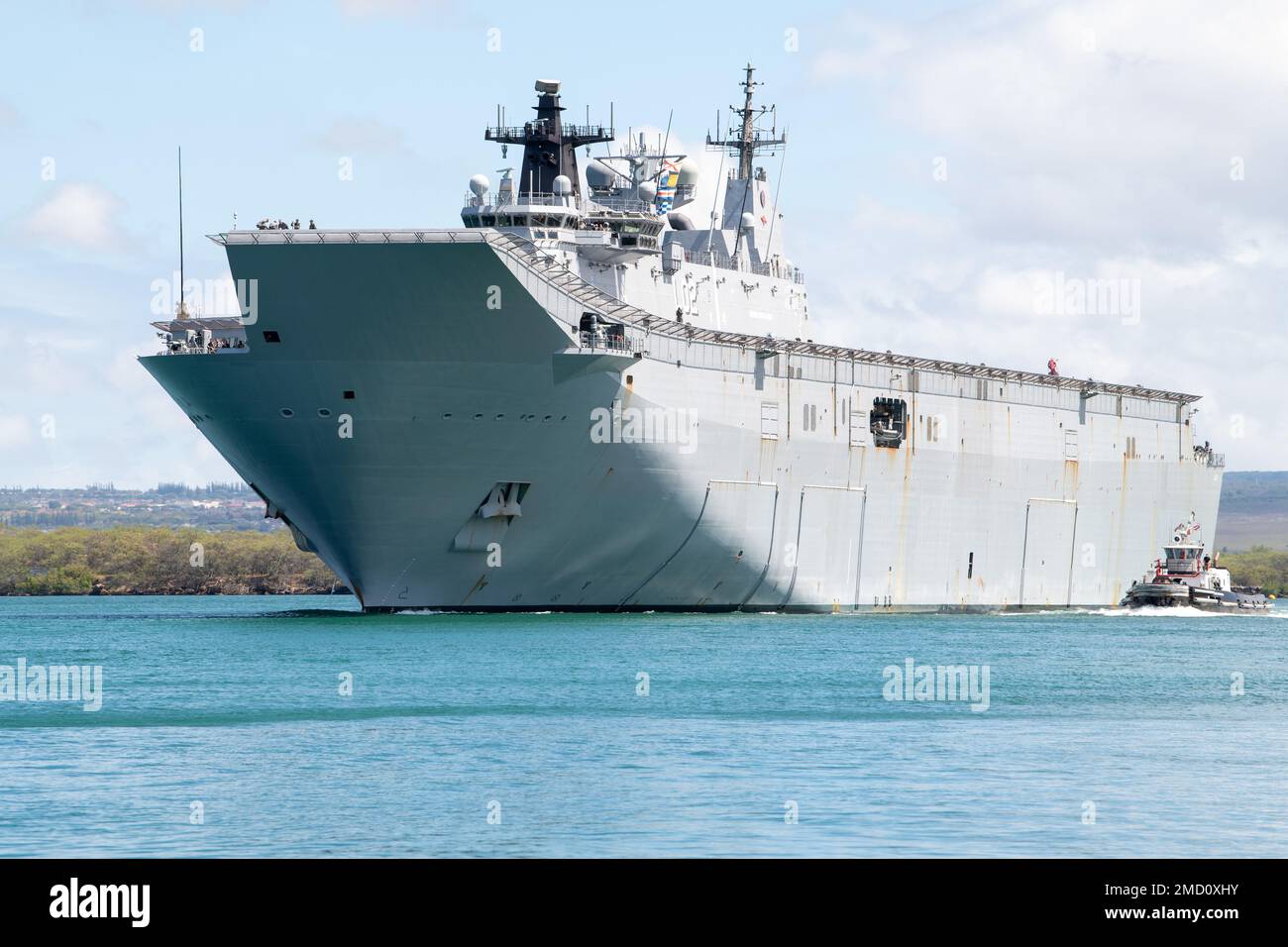 220712-N-RG360-1042  PEARL HARBOR (July 12, 2022) – Royal Australian Navy landing helicopter dock HMAS Canberra (L02) departs Pearl Harbor to begin the at-sea phase of Rim of the Pacific (RIMPAC) 2022, July 12. Twenty-six nations, 38 ships, four submarines, more than 170 aircraft and 25,000 personnel are participating in RIMPAC from June 29 to Aug. 4 in and around the Hawaiian Islands and Southern California. The world’s largest international maritime exercise, RIMPAC provides a unique training opportunity while fostering and sustaining cooperative relationships among participants critical to Stock Photo