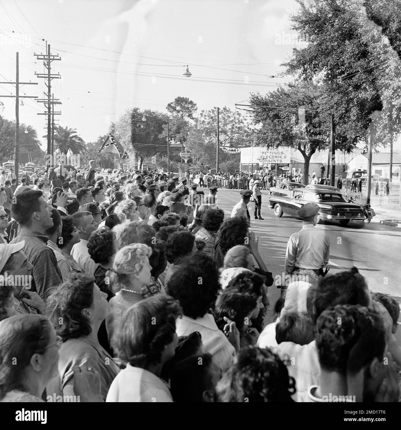 The hundreds of people outside newly integrated McDonogh 19 Elementary  School are held back by a line of city police officers in New Orleans on  Nov. 14, 1960, as Deputy U.S. Marshals,