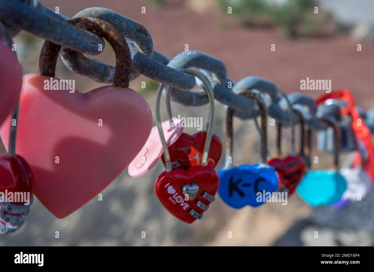 Love locks on a metal chain placed by lovers to declare their love. Found in Playa Flamingo in Lanzarote Stock Photo