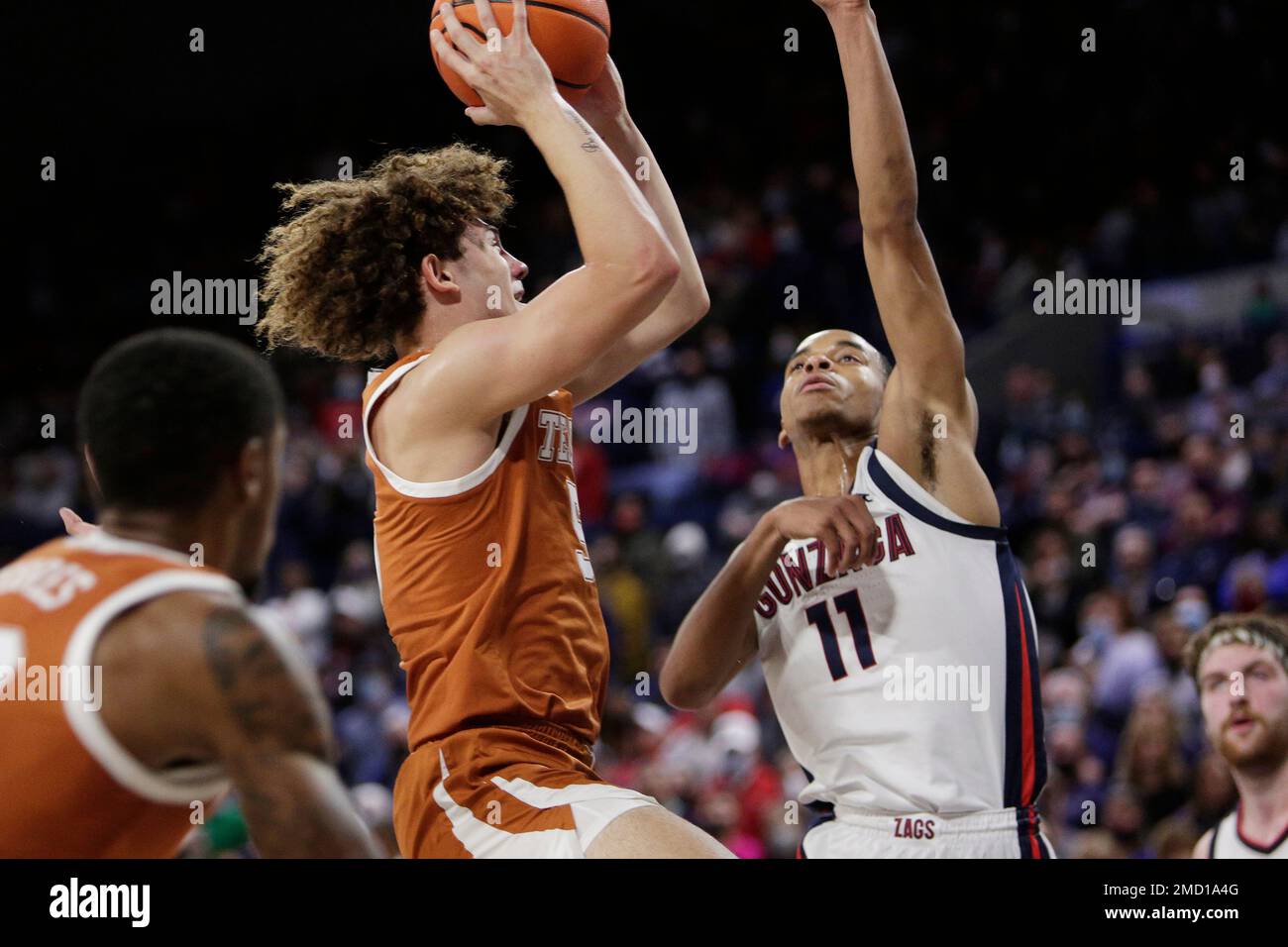 Texas guard Devin Askew, left, shoots while pressured by Gonzaga guard Nolan Hickman during the