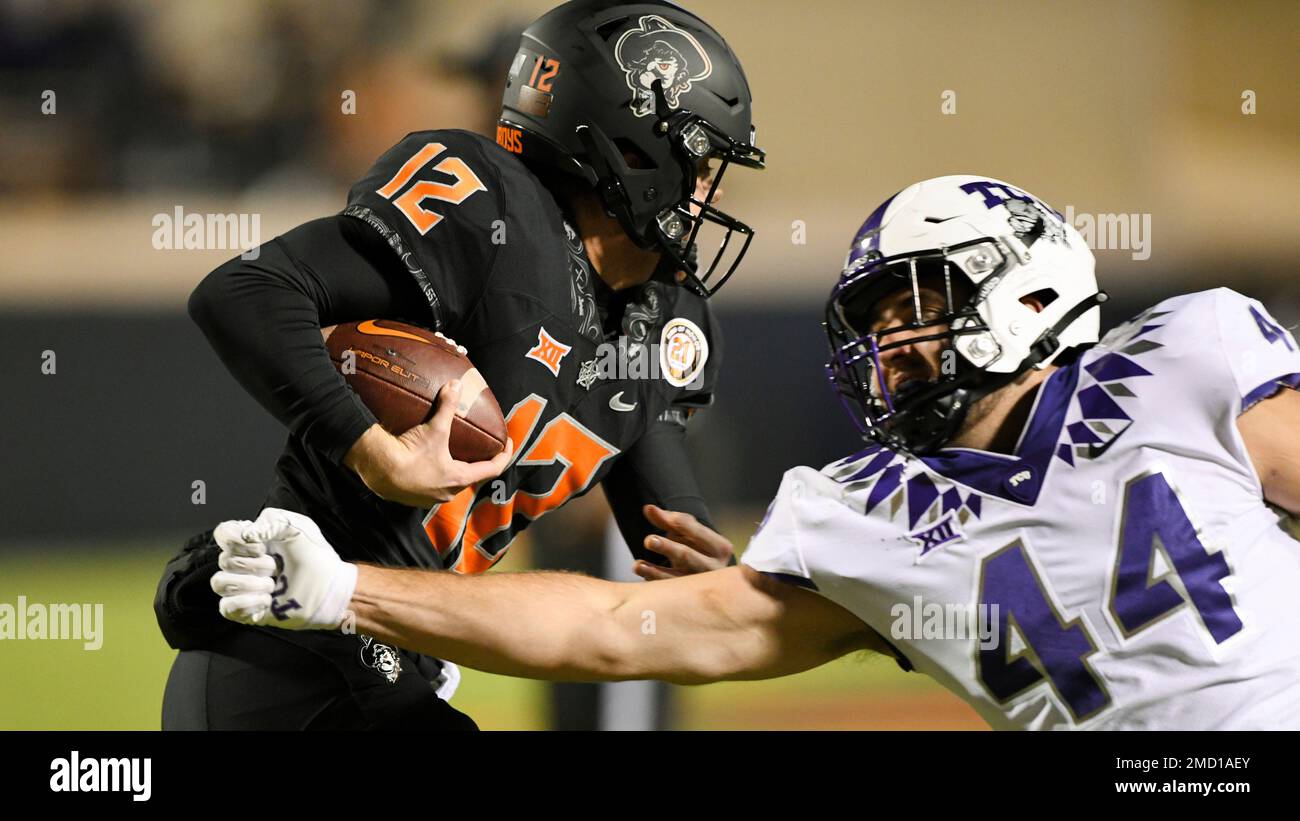 Oklahoma State Quarterback Gunnar Gundy 12 Evades A Tackle By Tcu Defensive End Colt Ellison 3686