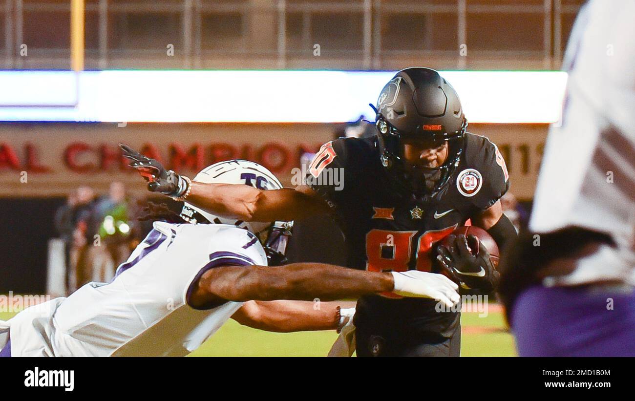 Oklahoma State Wide Receiver Brennan Presley (80) Attempts To Fend Off ...