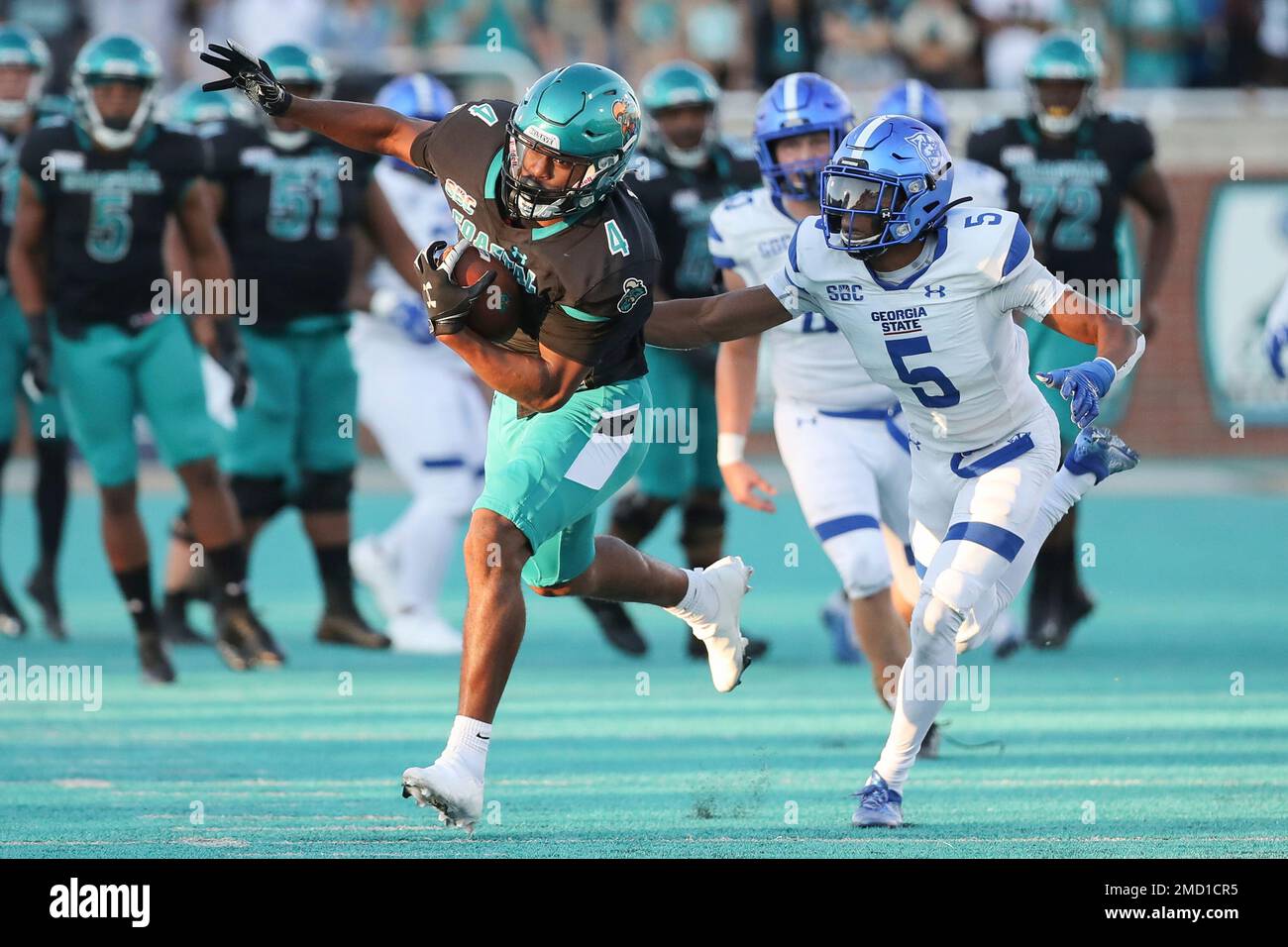 Coastal Carolina tight end Isaiah Likely (4) makes a one-handed catch against Georgia State cornerback Bryquice Brown (5) during the second half of an NCAA college football game Saturday, Nov. 13, 2021, in Conway, S.C. (AP Photo/Artie Walker, Jr.) Stock Photo