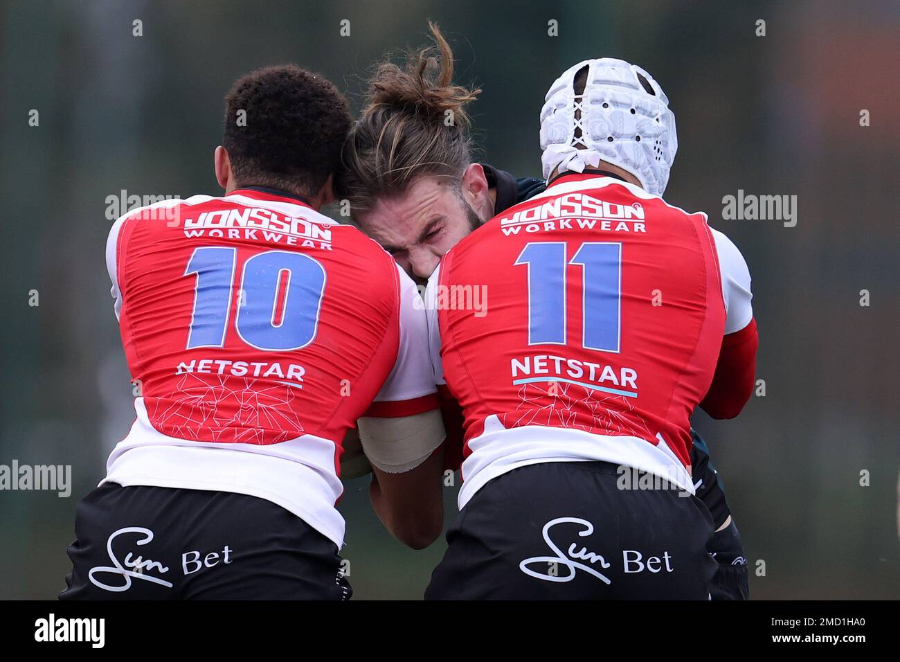 Ystrad Mynach, UK. 22nd Jan, 2023. Max Clark of Dragons (c) is stopped by Jordan Hendrikse (10) & Edwill van der Merwe (11) of Emirates Lions. European challenge cup rugby, pool B match, Dragons v Emirates Lions at the CCBC Centre for Sporting Excellence in Ystrad Mynach, Wales on Sunday 22nd January 2023. pic by Andrew Orchard/Andrew Orchard sports photography/Alamy Live news Credit: Andrew Orchard sports photography/Alamy Live News Stock Photo