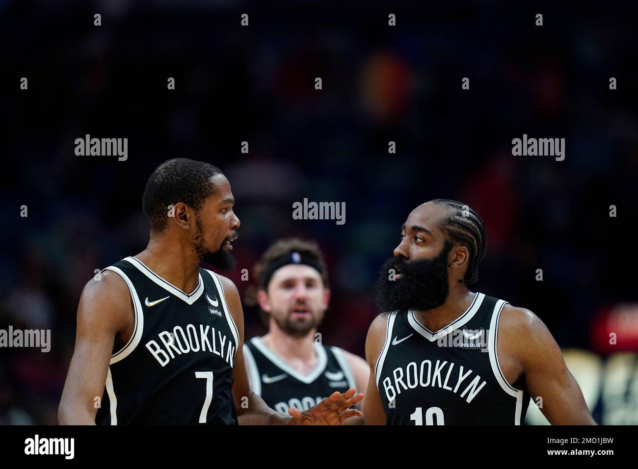 Brooklyn Nets guard James Harden (13) talks with forward Kevin Durant (7) in the second half of an NBA basketball game against the New Orleans Pelicans in New Orleans, Friday, Nov. 12, 2021. The Nets won 120-112. (AP Photo/Gerald Herbert) Stock Photo