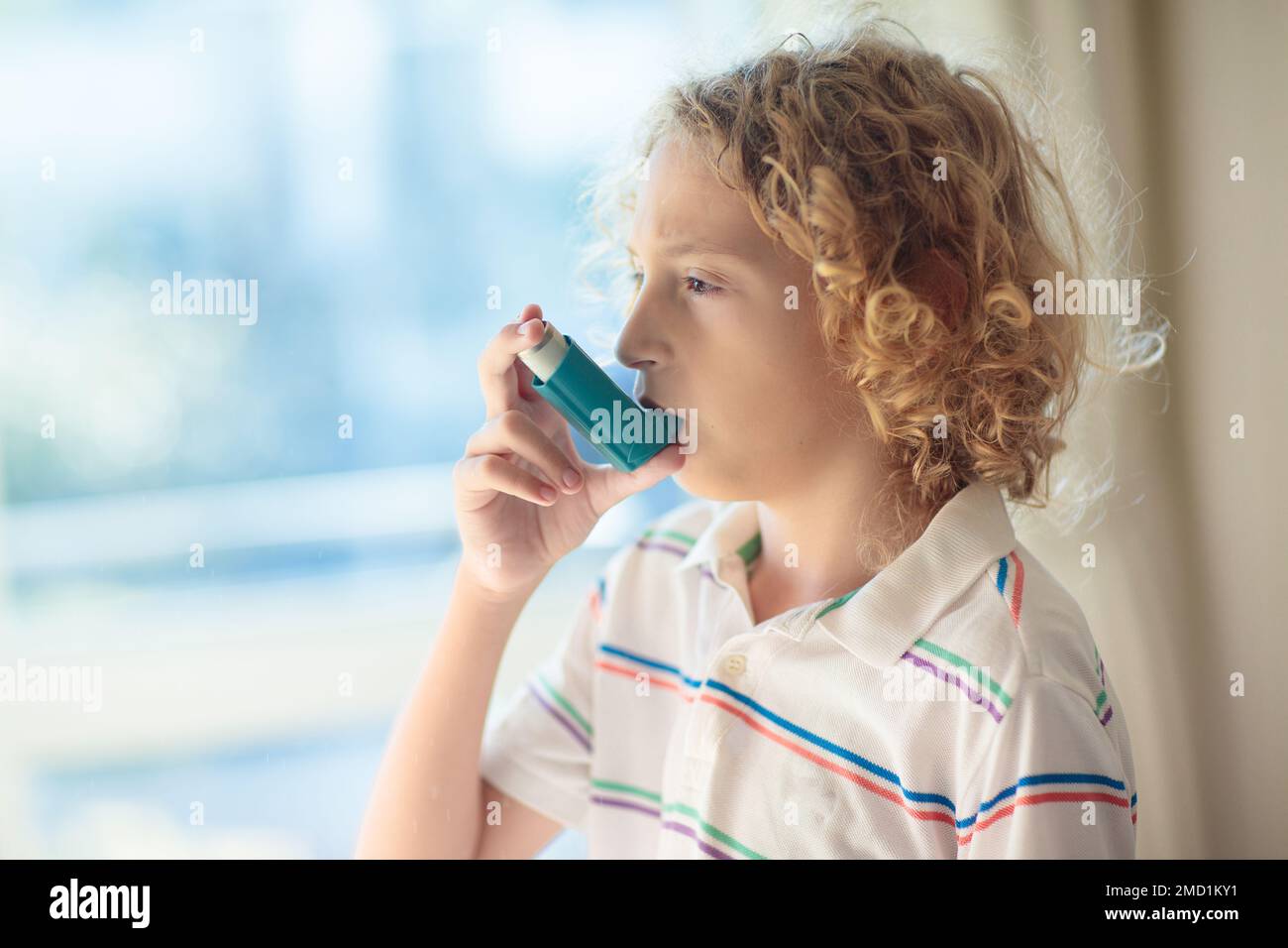 Sick child sneezing and coughing in paper tissue. Allergy treatment