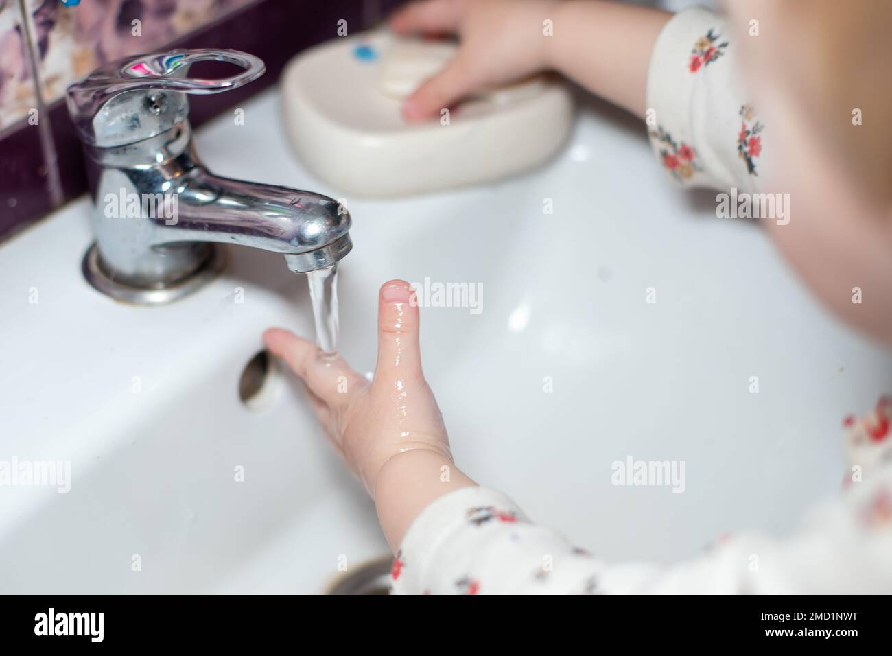 Small child washing hands with soap and water, cleaning hand to stop