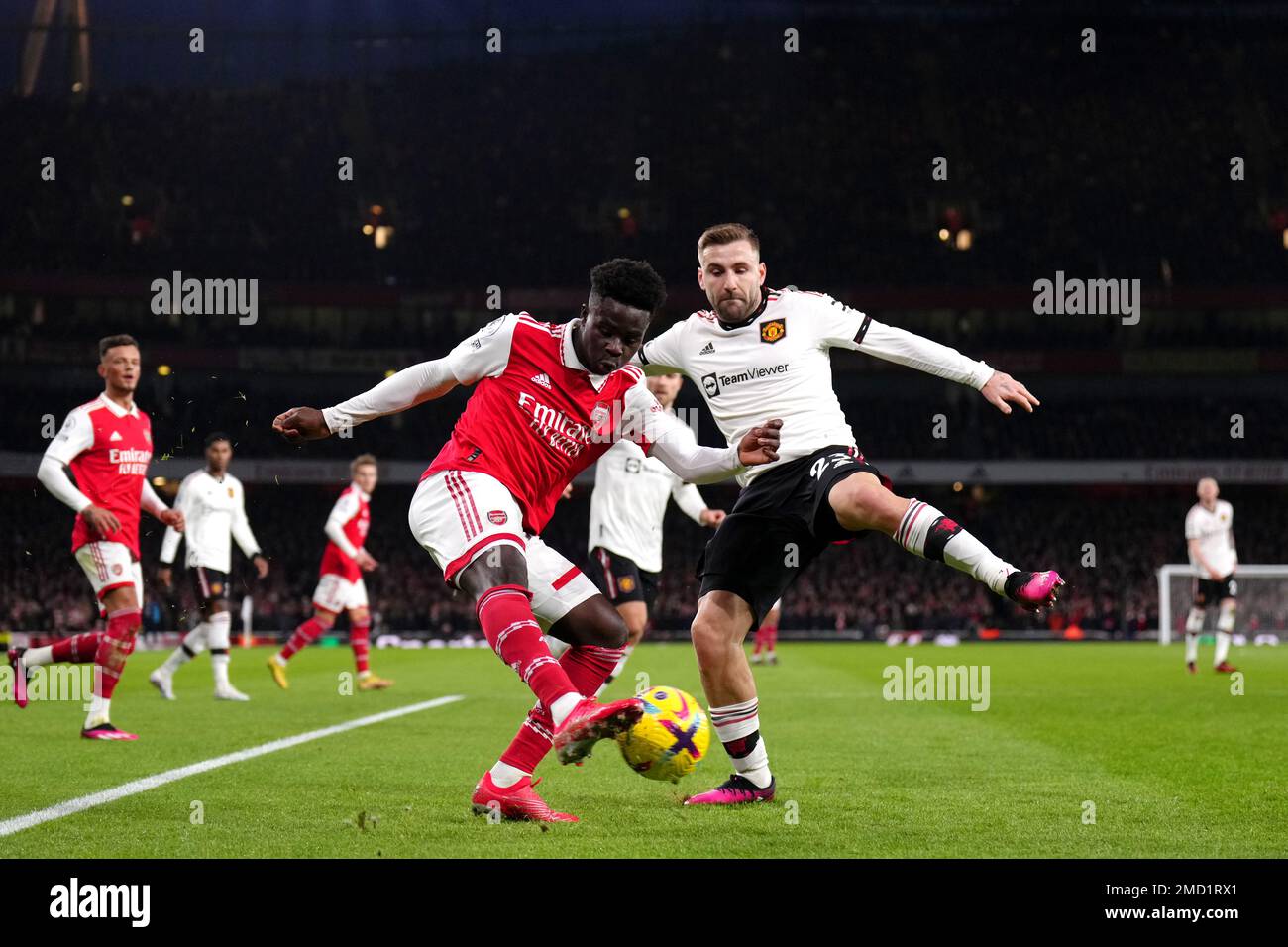 Arsenal's Bukayo Saka (left) and Manchester United's Luke Shaw battle for the ball during the Premier League match at the Emirates Stadium, London. Picture date: Sunday January 22, 2023. Stock Photo