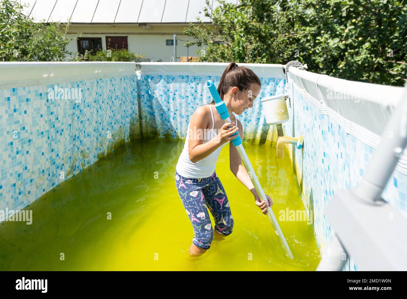 a little girl cleans a very dirty pool Stock Photo Alamy