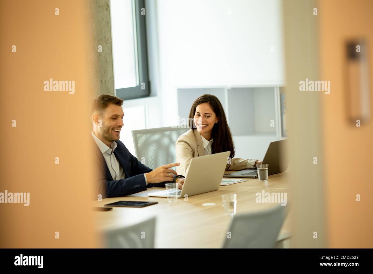 Businessman and businesswoman working together in office Stock Photo