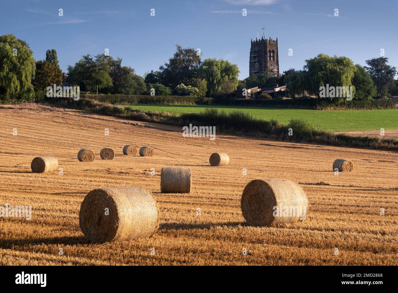 Hay Bales below St Mary’s Church near Great Budworth, Great Budworth, Cheshire, England, UK Stock Photo
