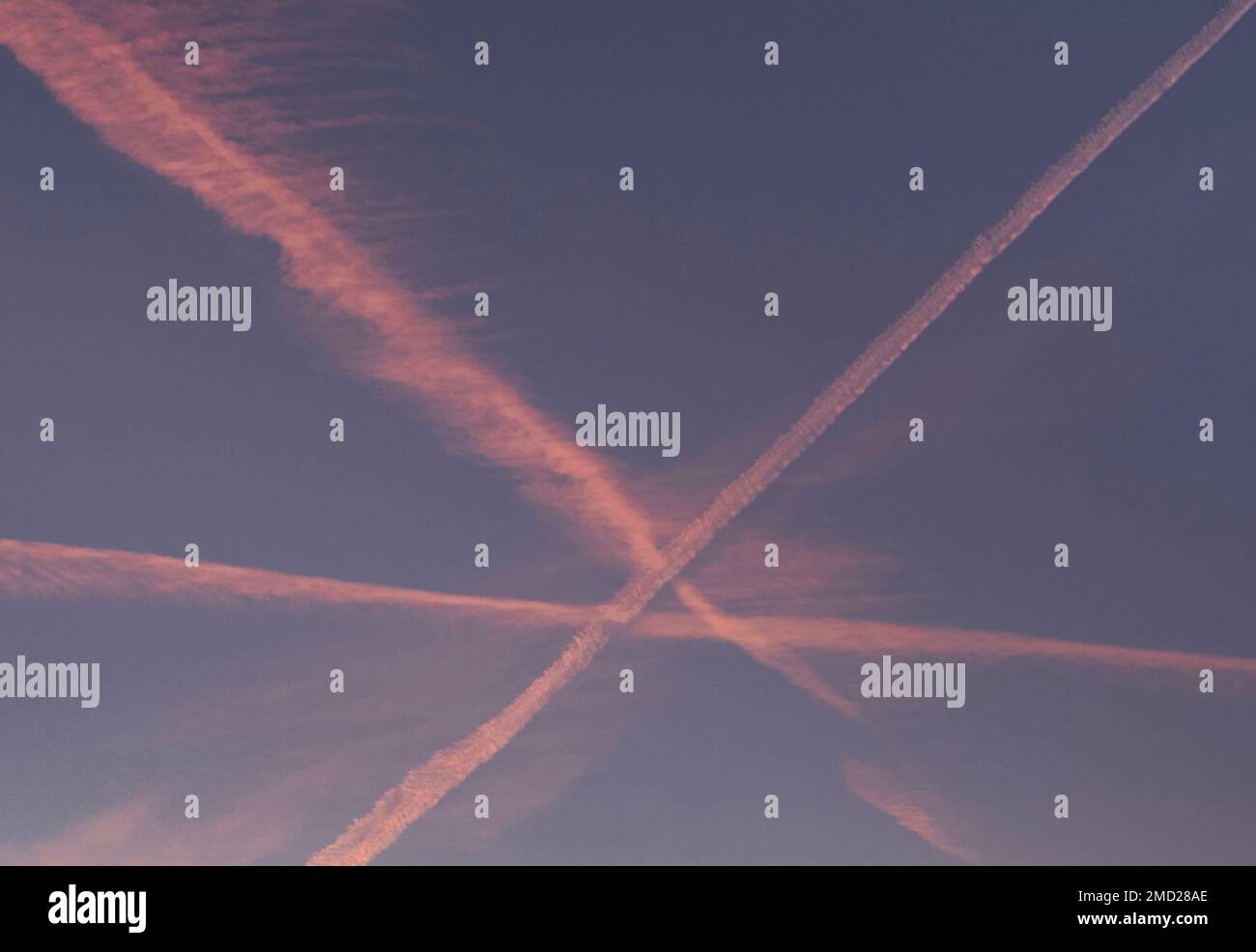 Aircraft Contrails at sunset, above the Peak District National Park, Cheshire, England, UK Stock Photo