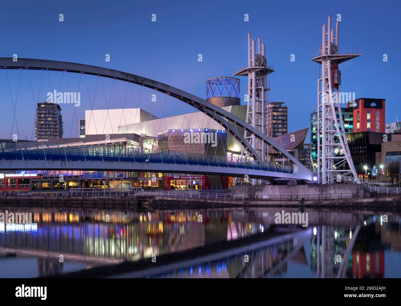 The Lowry Footbridge & Lowry Centre at night, Salford Quays, Salford, Manchester, England, UK Stock Photo