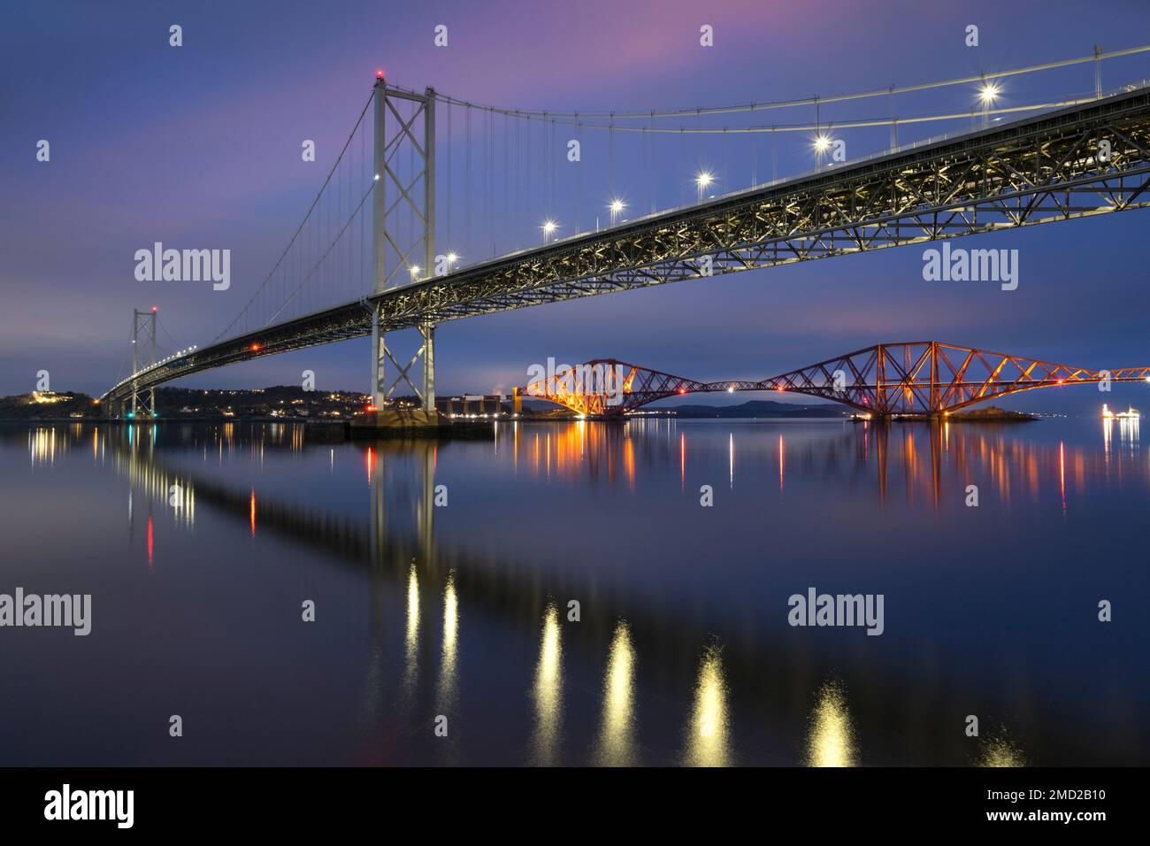 The Forth Road Bridge and Forth Railway Bridge at night spanning the Firth of Forth, Queensferry, near Edinburgh, Scotland, UK Stock Photo
