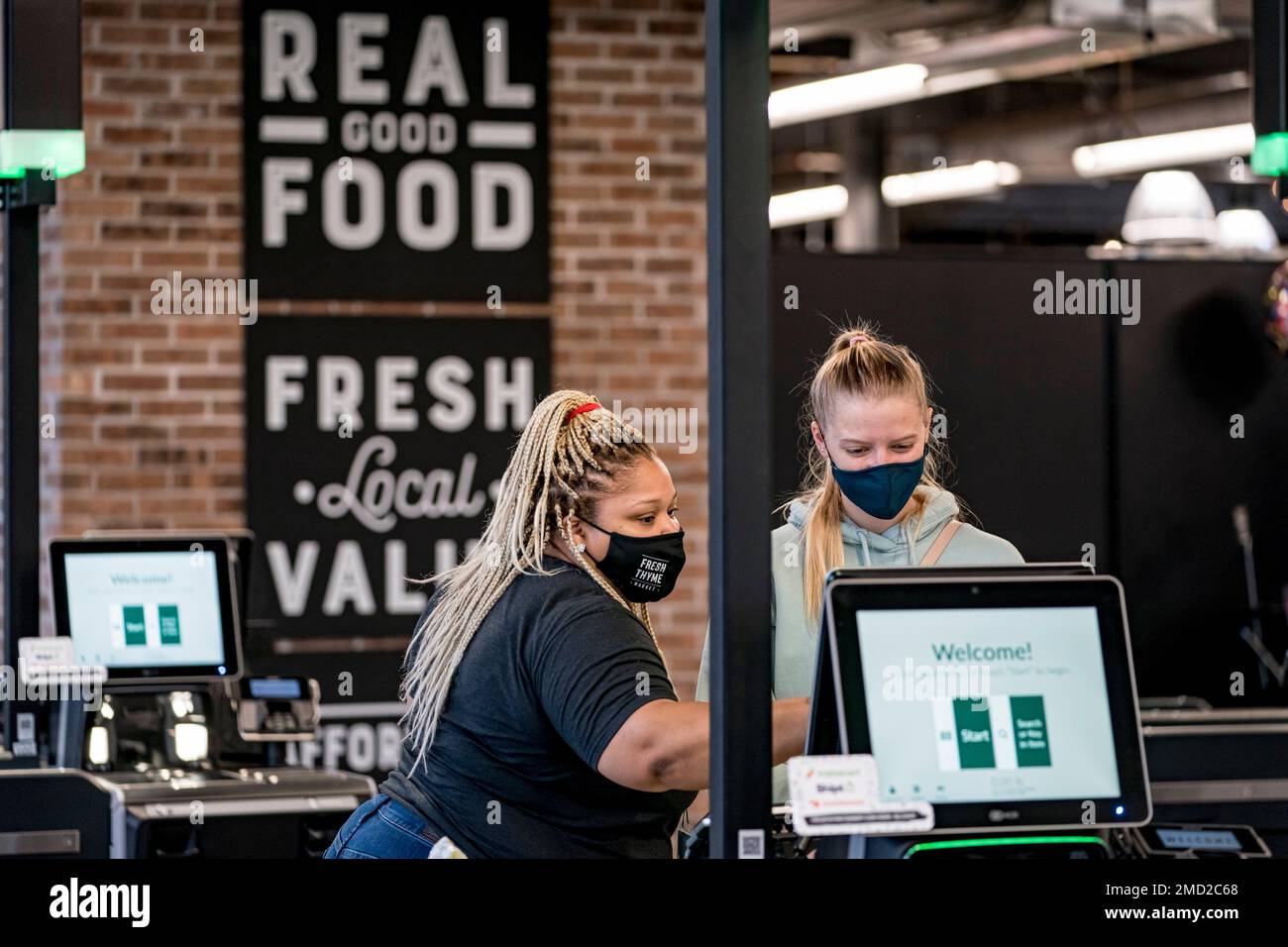 IMAGE DISTRIBUTED FOR FRESH THYME MARKET An employee assists a