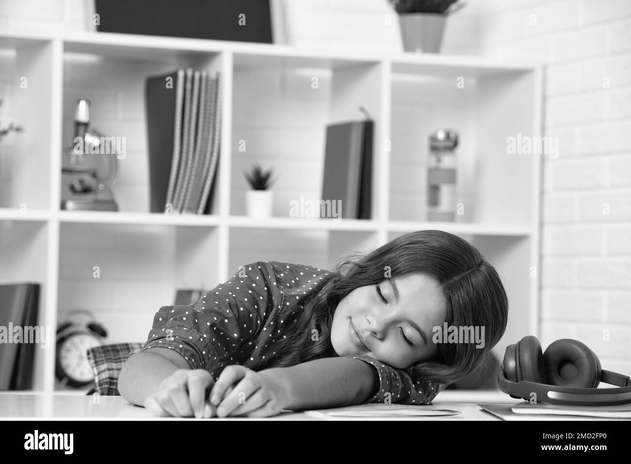 Tired and bored teenager school girl. Schoolgirl is sleeping while doing homework, tired from studying, exhausted. Stock Photo