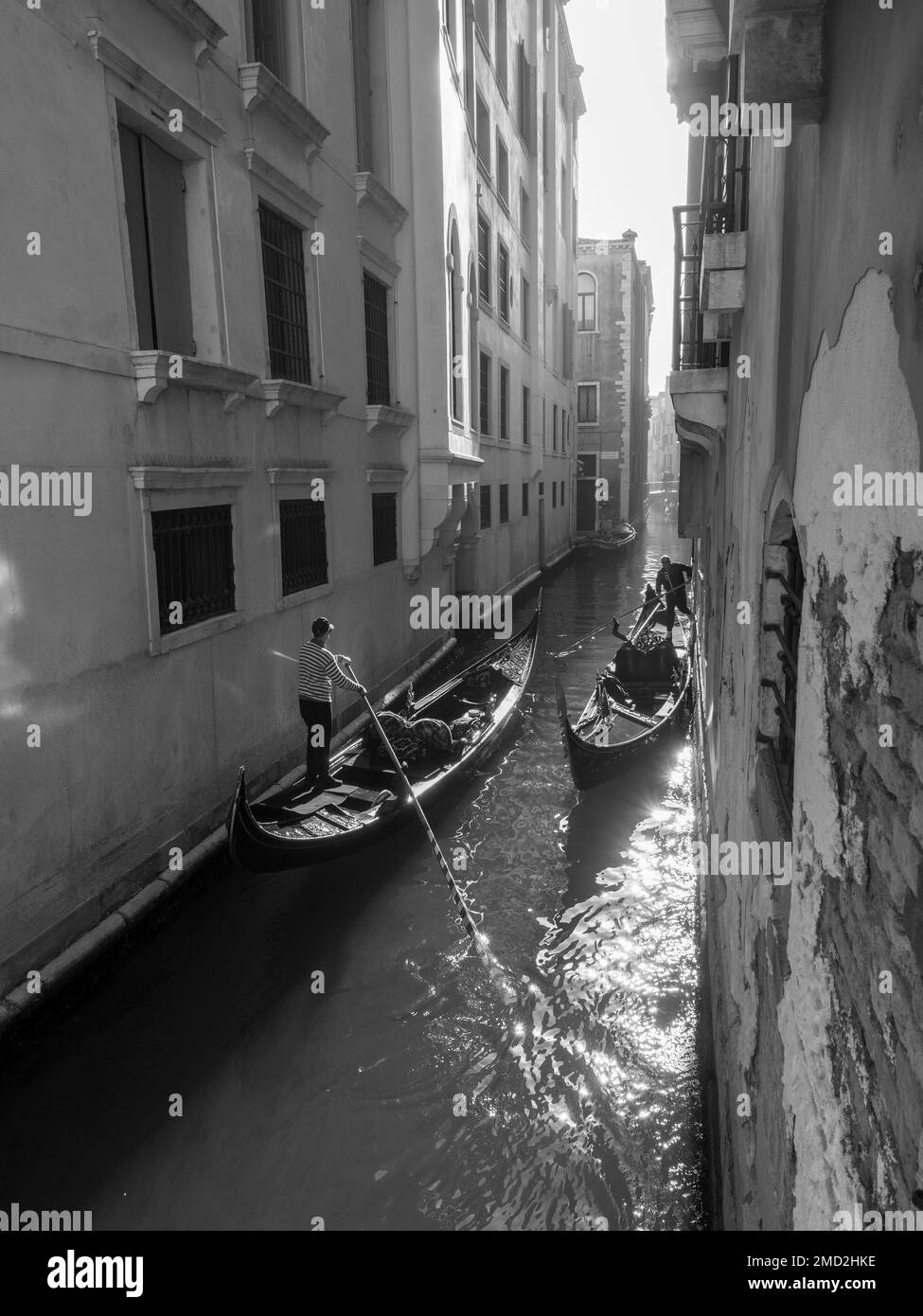 October 31, 2022 - Venice, Italy: Black and white photo of two gondolas in a canal of Venice. Tourism concept. Stock Photo
