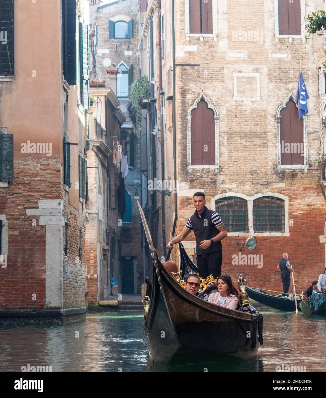 October 31, 2022 - Venice, Italy: Tourists taking a gondola ride in Venice. Tourism concept. Stock Photo