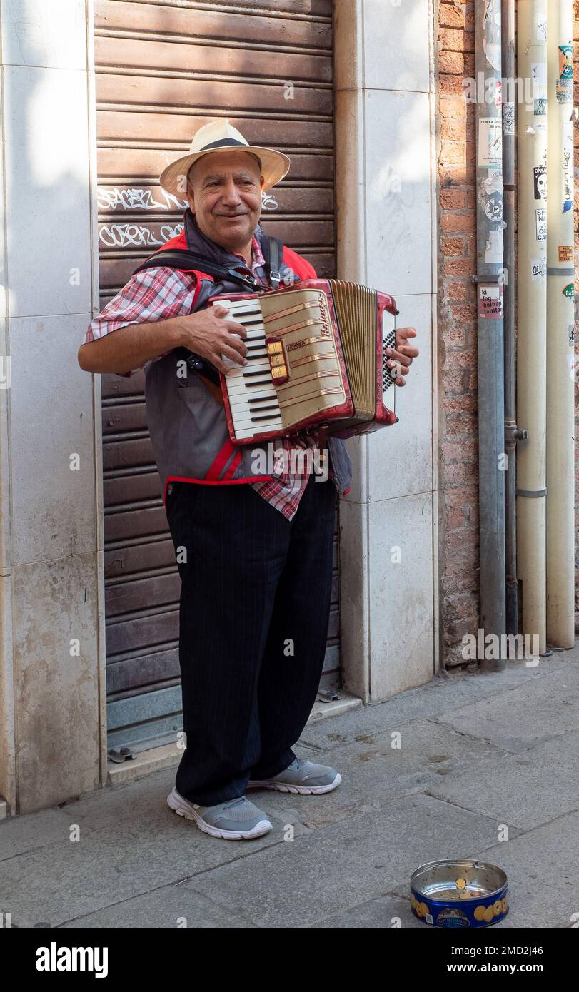 October 31, 2022 Venice, Italy Man playing the harmonica in the