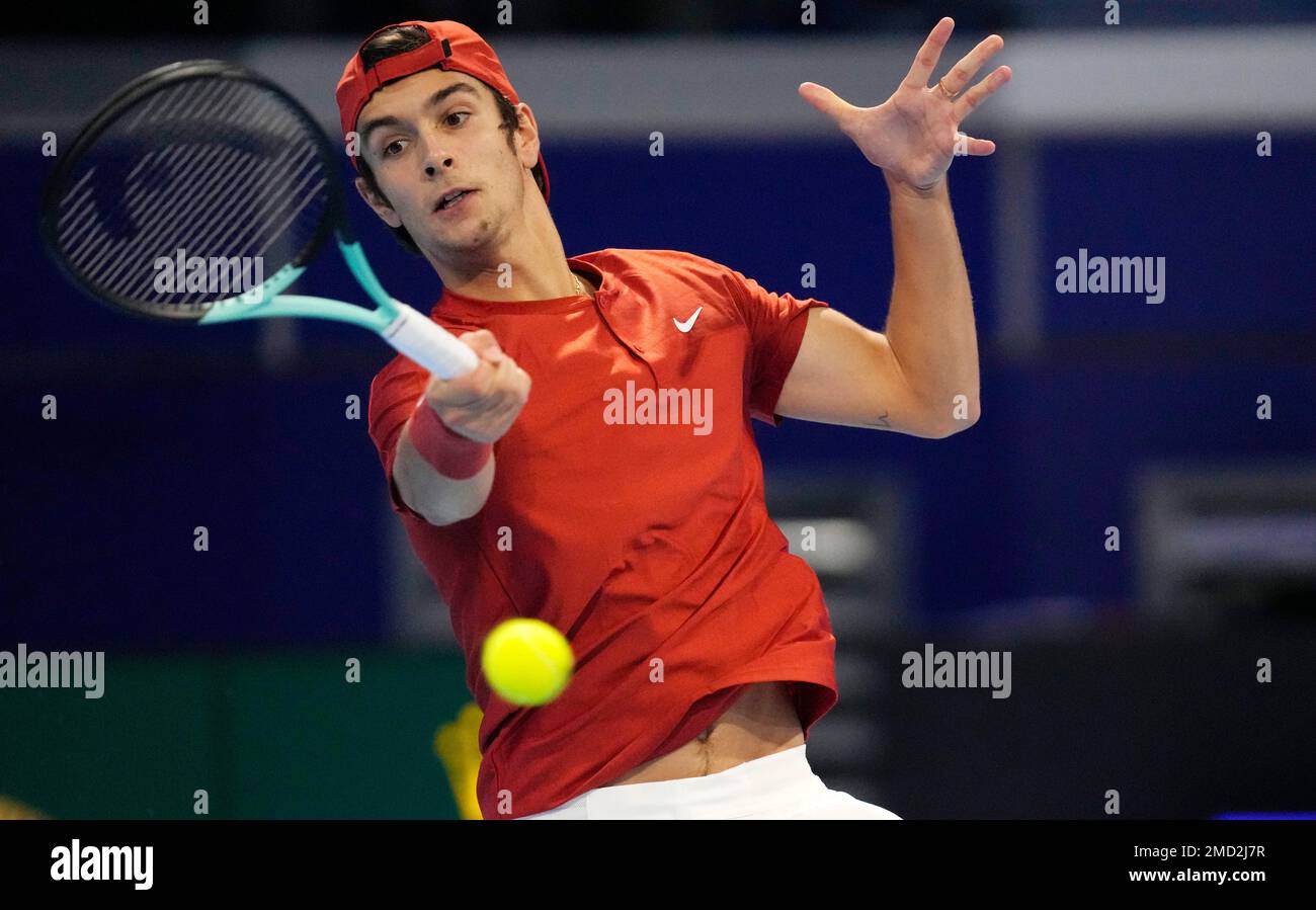 Italy's Lorenzo Musetti returns the ball to Argentina's Sebastian Baez