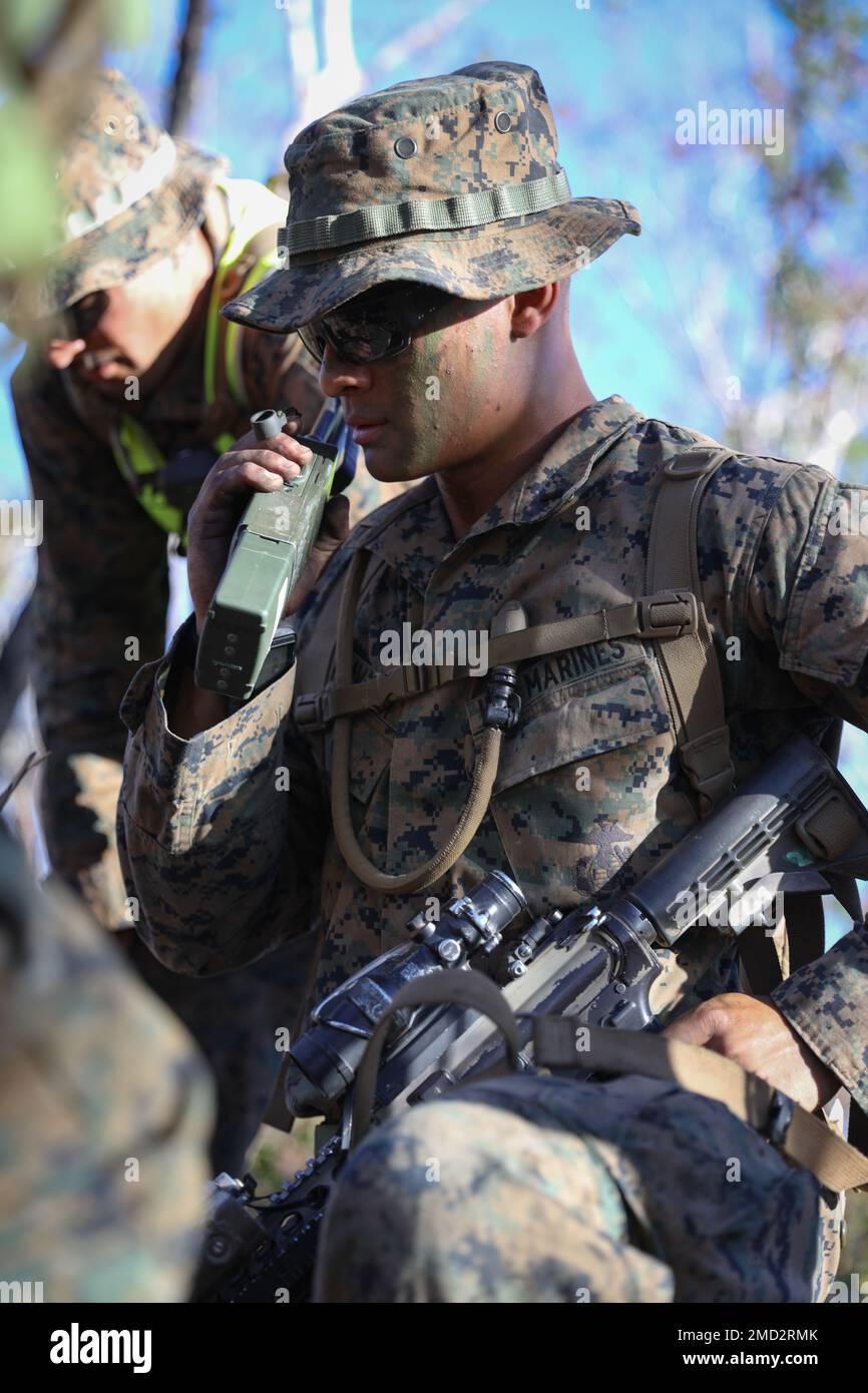 U.S. Marine Corps 1st Lt. Daniel Chiavacci, a platoon commander with Lima Co., 3d Battalion, 7th Marine Regiment, Ground Combat Element, Marine Rotational Force-Darwin 22, communicates over radio during company attacks as part of exercise Koolendong 22 at Mount Bundey Training Area, NT, Australia, July 12, 2022. Exercise Koolendong 22 is a combined and joint force exercise focused on expeditionary advanced base operations conducted by U.S. Marines, U.S. Soldiers, U.S. Airmen, and Australian Defence Force personnel. Stock Photo