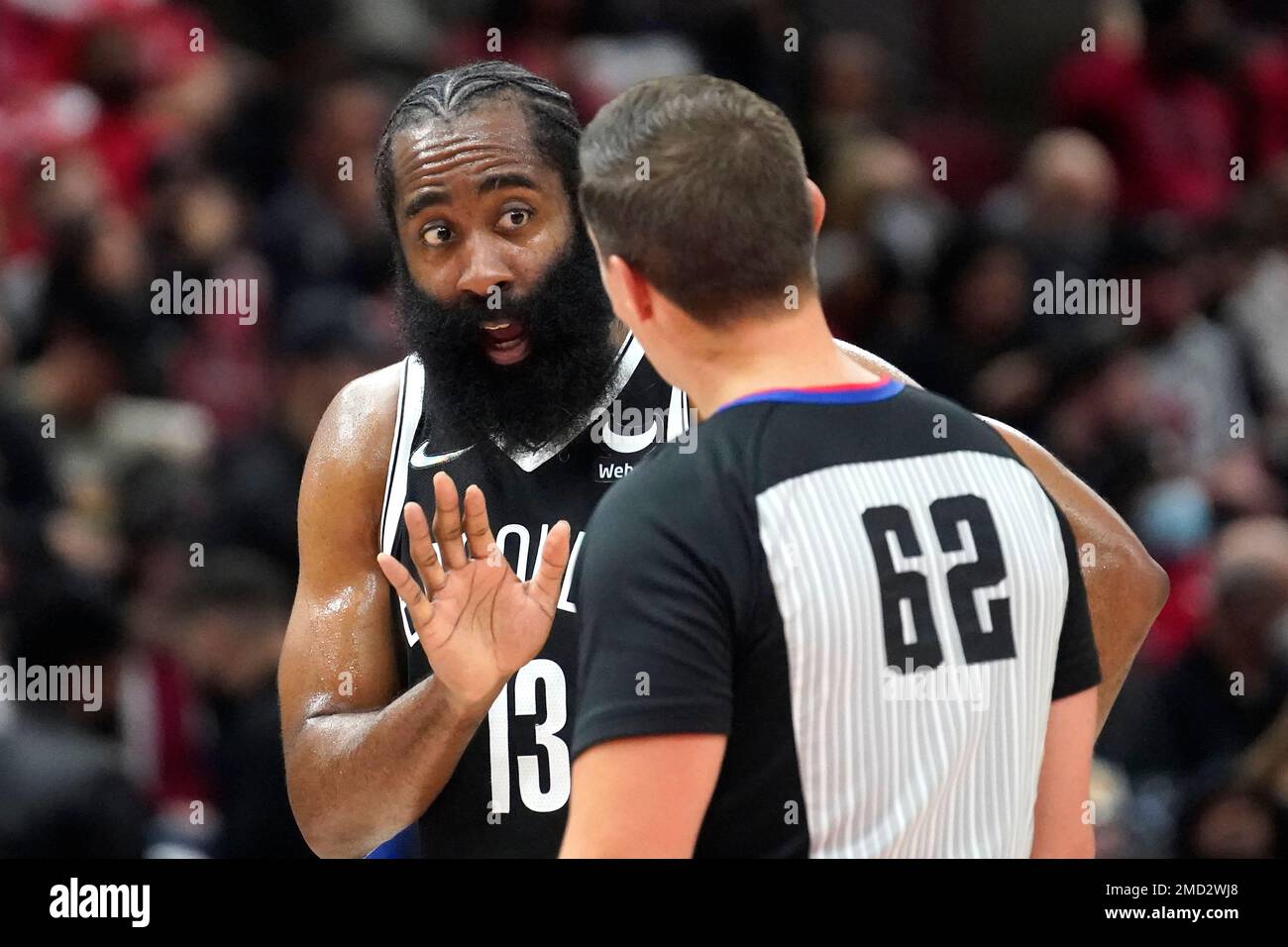 Brooklyn Nets' James Harden (13) talks with referee JB DeRosa (62) about a  foul Harden was called on during the first half of an NBA basketball game  against the Chicago Bulls Monday,