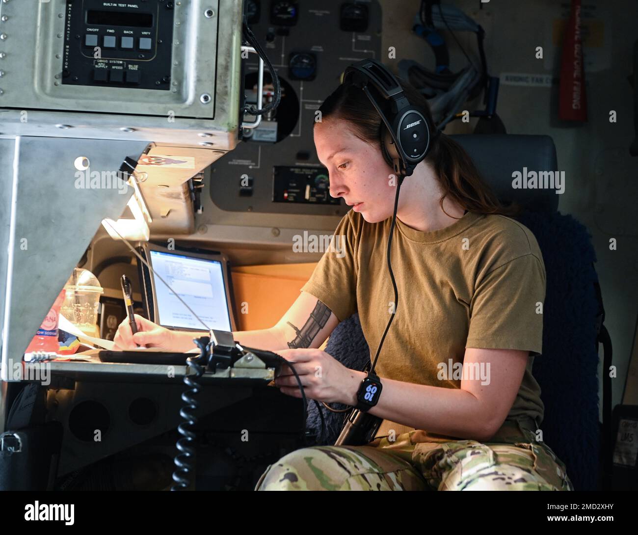 U.S. Air Force Senior Airman Nicole Snowden, an 816th Expeditionary Airlift Squadron loadmaster, goes through a preflight checklist July 12, 2022 at Al Udeid Airbase, Qatar. Loadmasters are responsible for the on-load, securing and off-load of any cargo on board an aircraft, as well as any passengers who may be flying. Stock Photo