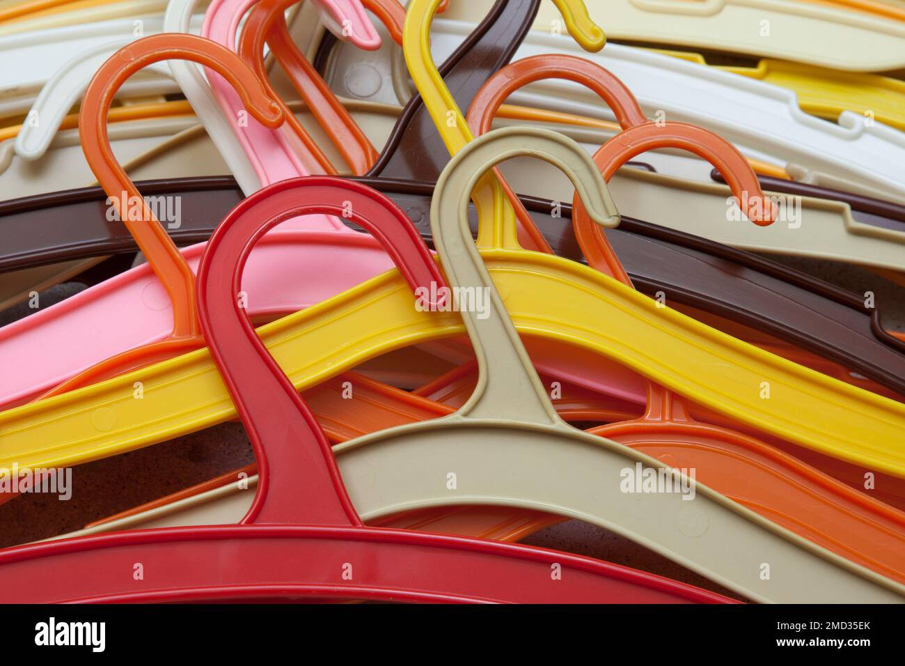 Colorful mess. A pile of colored plastic hangers. Stock Photo