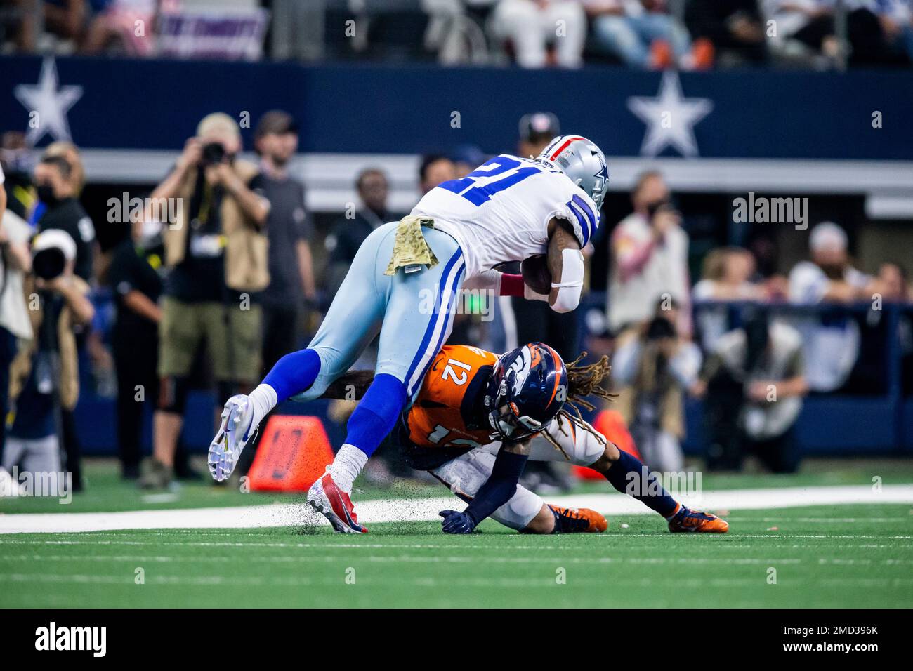 Denver Broncos defensive back Mike Ford (12) tackles Dallas