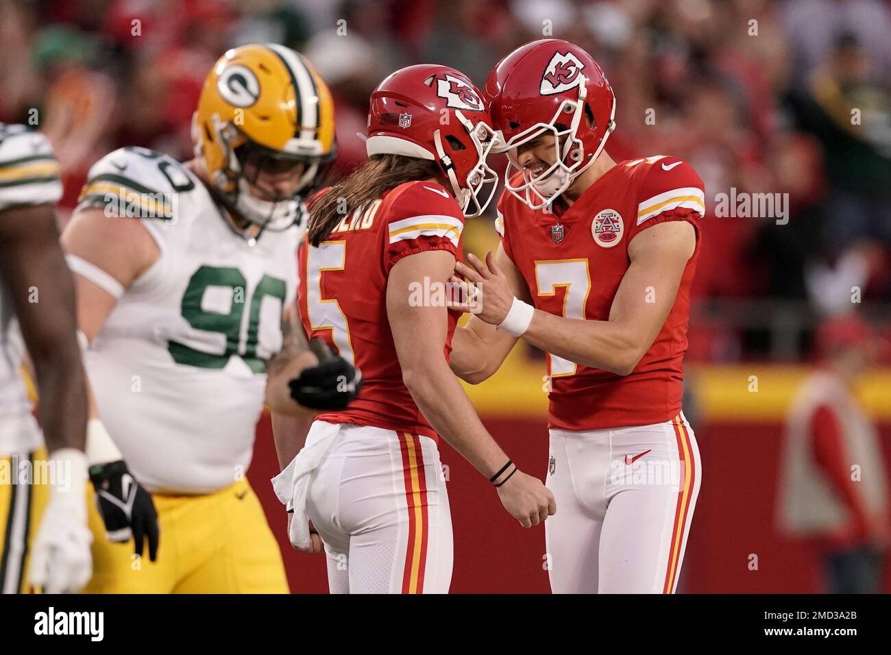 Kansas City Chiefs place kicker Harrison Butker (7) is congratulated by  Tommy Townsend (5) after making a field goal as Green Bay Packers defensive  tackle Jack Heflin (90) walk past during the