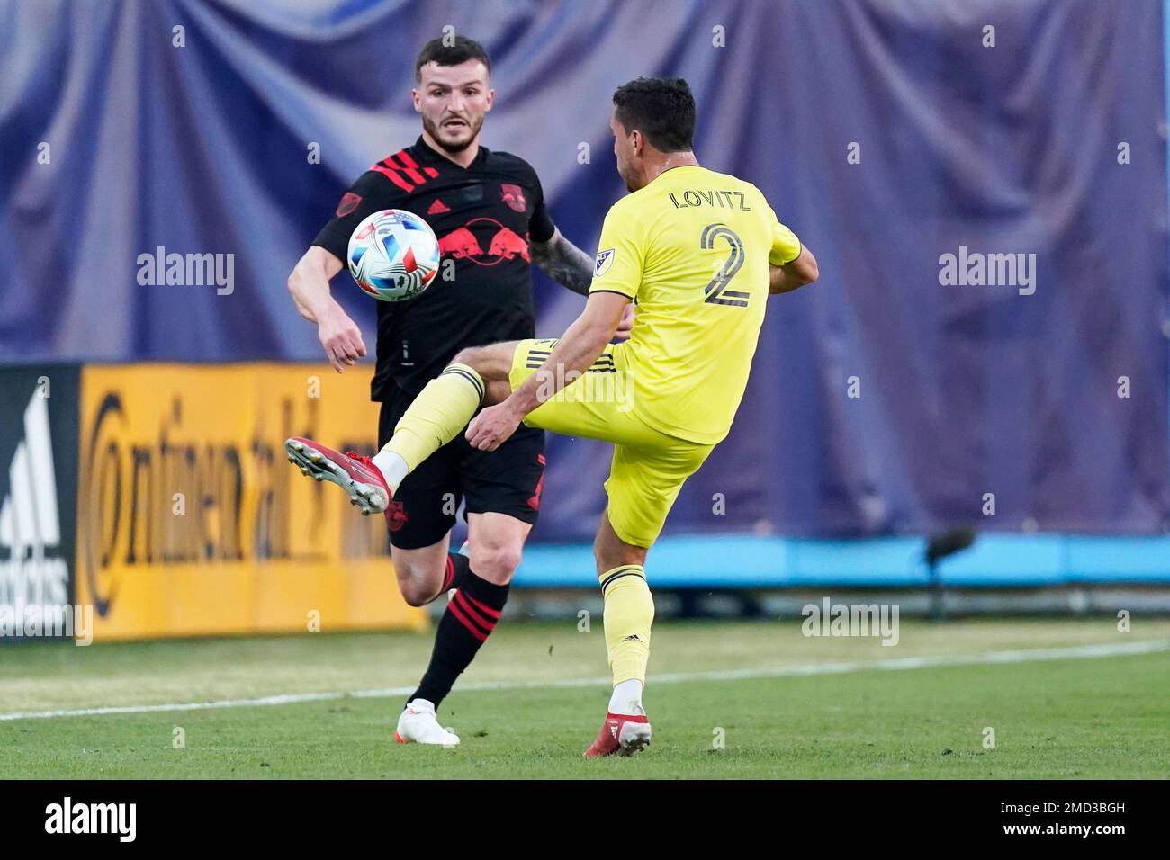 New York Red Bulls' Tom Edwards (7) and Nashville SC's Daniel Lovitz (2) vie for the ball in the