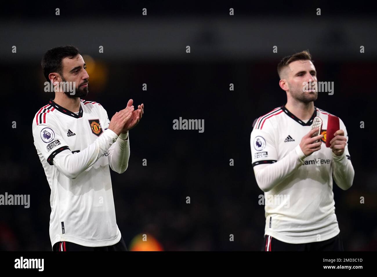 Manchester United's Bruno Fernandes and Luke Shaw applaud the fans following the Premier League match at the Emirates Stadium, London. Picture date: Sunday January 22, 2023. Stock Photo