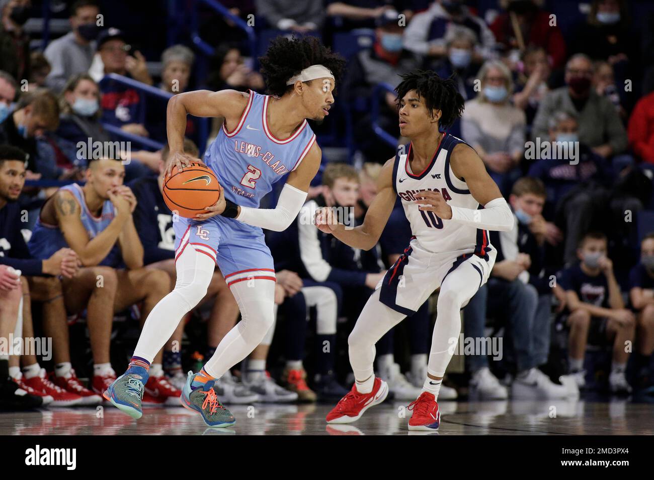Lewis-Clark State guard Khalil Stevenson (2) controls the ball while  defended by Gonzaga guard Hunter Sallis (10) during the second half of a college  basketball exhibition game, Friday, Nov. 5, 2021, in
