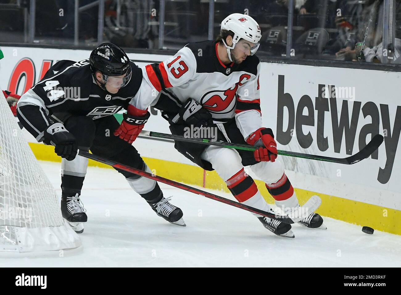 New Jersey Devils center Nico Hischier (13) defends against Columbus Blue  Jackets center Kent Johnson (91) during the third period of an NHL hockey  game Thursday, April 6, 2023, in Newark, N.J.